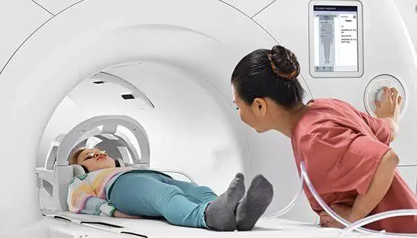 Why are no metallic items allowed to be worn inside an MRI room?